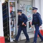 Police walk into a Dunedin dairy during inspections yesterday afternoon to find out whether...