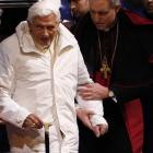 Pope Benedict XVI is assisted as he arrives to attend a meeting with seminarians at the Romano...