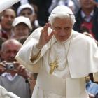 Pope Benedict XVI waves from the popemobile following his weekly general audience, in St Peter's...