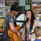 Postal band member Jason Grice,  of Sydney, and Gore's Jenny Mitchell (13) busk at the Tamworth...