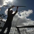 Power Options director Ian Buchan installs a solar water heating system at a Maori Hill property...