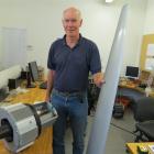 Powerhouse Wind director Bill Currie shows off parts of his Thinair one-bladed windmill which is...