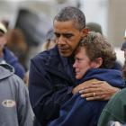 President Barack Obama hugs North Point Marina owner Donna Vanzant as he tours damage done by...