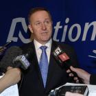 Prime Minister Rt Hon John Key answers questions from media after talking at the National Party...