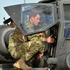 Prince Harry examines the cockpit of an Apache helicopter at Camp Bastion in Afghanistan at the...