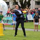 Prince William, Duke of Cambridge plays a game of cricket during a visit to Latimer Square in...