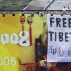 Pro Tibet activists unfurl a "Free Tibet" banner and Tibetan flags on top of a Beijing Olympics...