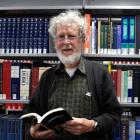 Prof Jim Flynn with a copy of his book in the University of Otago central library. Photo by...