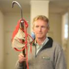 Profile ... Department of Conservation marine ranger Jim Fyfe with the item he removed from a...