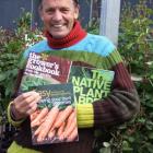 Prolific garden writer Dennis Greville with three of his recent books. Photo by Gillian Vine.