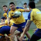 Prop Kees Meeuws looks to pass the ball to centre Ben Atiga at Otago training at Carisbrook...