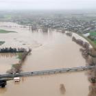 Protected by behind a floodbank, Outram is flanked by the flooding  Taieri River on Saturrday....