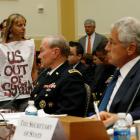Protester Medea Benjamin is pictured alongside US General Martin Dempsey, chairman of the Joint...