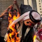 Protesters burn an effigy of Qatar's Emir Sheikh Hamad bin Khalifa al-Thaniat during a...