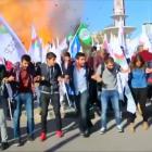 Protesters dance during a peace rally as a blast goes off in Ankara, Turkey at the weekend in...