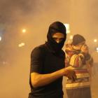 Protesters opposing Egyptian President Mohamed Mursi and the Muslim Brotherhood run from tear gas...