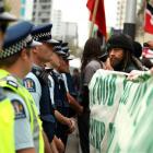 Protestors stand on the edge of Queen Street outside Aotea Square in Auckland city.  Photograph...