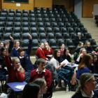 Pupils raise their hands to take part in the spot prize section of the quiz. Photos by Liam...