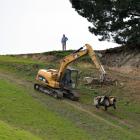 Contractors remove a quad bike yesterday after a fatality in Berwick Rd, near Waihola. Photo by...