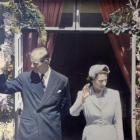 Queen Elizabeth and Prince Philip greet their Dunedin subjects from the balcony of the Law Courts...