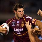 Queensland's David Taylor tries to fend off a New South Wales tackle rin game one of the State of...