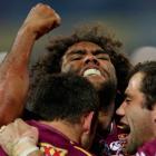 Queensland's Sam Thaiday celebrates with teammates after scoring a try against New South Wales in...