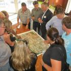 Queenstown Airport Corporation chief executive Scott Paterson (top, third from left) talks to...