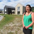 Queenstown Lakes Community Housing Trust executive officer Julie Scott stands in front of two of...