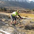 Queenstown Mountain Bike Club member Carey Vivian navigates frozen mud after a downward slope...