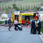 Queenstown police and Frankton firefighters help people clear a section of Lake Hayes Estates...