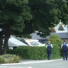 Queenstown police officers search the Frankton street  in which a man was allegedly seen with  a...