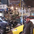 Queenstown resident John Taylor surrounded by vehicles and memorabilia in his private motor...