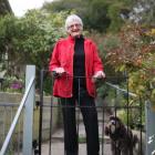 Rae McLeod and her dog, Dougall, stand by their new wrought iron gate, given  by a Dunedin...