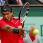 Rafael Nadal of Spain returns the ball to Novak Djokovic of Serbia during their singles final at...