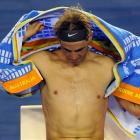 Rafael Nadal of Spain wipes himself during a break in his third round match against Bernard Tomic...