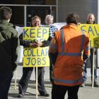 Rail and Maritime Transport Union national secretary Wayne Butson, centre, leads a picket line of...