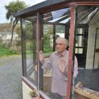 Ravensbourne resident Jim La Rooy looks out a self-cleaning glass window, which was installed by...