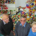 Ray Meikle (left), and Rex and Dorothy Murray take time out from sorting about a quarter of the...