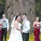 Rebecca Knight and Regan Brown with their wedding party at Mount Stuart Reserve, after their...