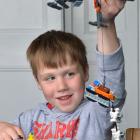 Micah Caldwell plays with Lego toys given to him after he was injured when a Noddy train...