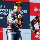 Red Bull driver Sebastian Vettel of Germany celebrates winning the German Grand Prix next to...