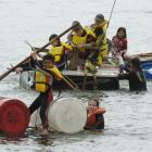 Reegan Gaualofa (9) brandishes an oar, while Savannah Flack (11) gets out to push, during the...
