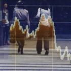 Reflections in a stock quotation board showing the falling Topix index outside a brokerage in...