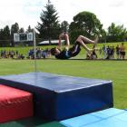 Regan Hucklebridge (13), of Cromwell College, clears the bar in the boys 13-plus high jump.