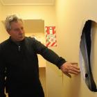 Regent Theatre technical manager Nelson Miles inspects damage done to a wall in the theatre...