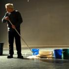 Regent Theatre technical manager Nelson Miles mops the floor after water cascaded on to the stage...