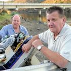Jack Pegg (left) and Warren White with Mr White's boat, which was lifted off the Taieri bar by...