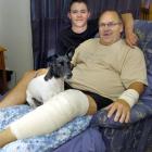 Rescued hunter Ken McFarlane at home with son Blake and dog Flash. Flash is not allowed on any...