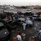 Residents gather at the site of a car bomb attack in Baghdad's Sadr City. REUTERS/Thaier al-Sudani