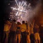 Revellers watch the Queenstown fireworks display which welcomed in 2006. Queenstown's Earnslaw...